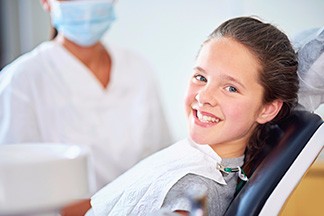 Young girl smiling in exam chair